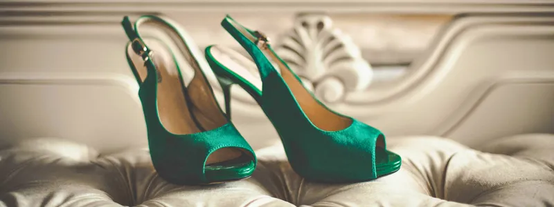 Activism in Heels: Outstanding Ignite 3 A pair of warm green high-heeled shoes standing on a luxurious white sofa.