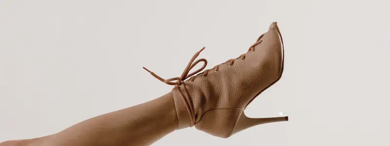 Eco-Friendly High Heels: Breaking Formula 2 An extended leg in a high-heeled shoe made from recycled eco-leather.