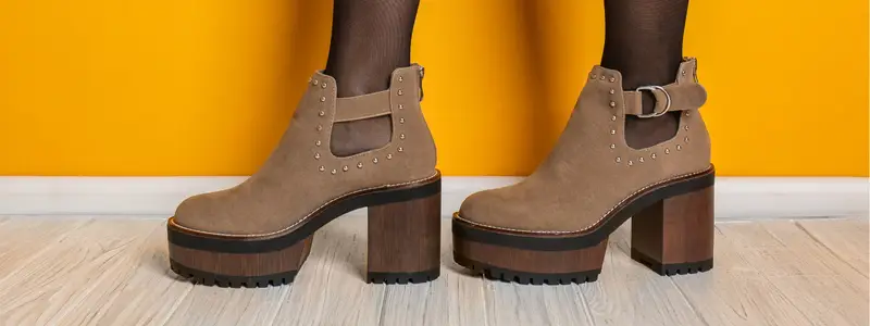 Comfortable autumn ankle boots with a wide heel and an elevated shaft, set in a yellow room.