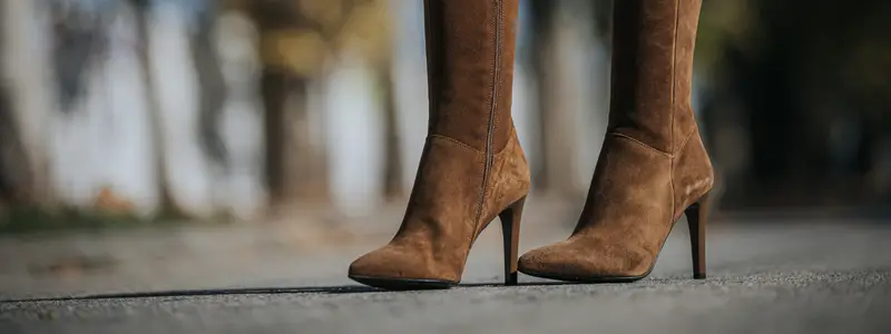 High eco-leather boots with a closed toe in brown, featuring a 3-inch stiletto heel.