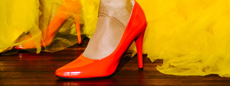 Glamorous Trends of High Heels 5 Feet of a person wearing a voluminous yellow tulle gown and bold red stiletto heels.