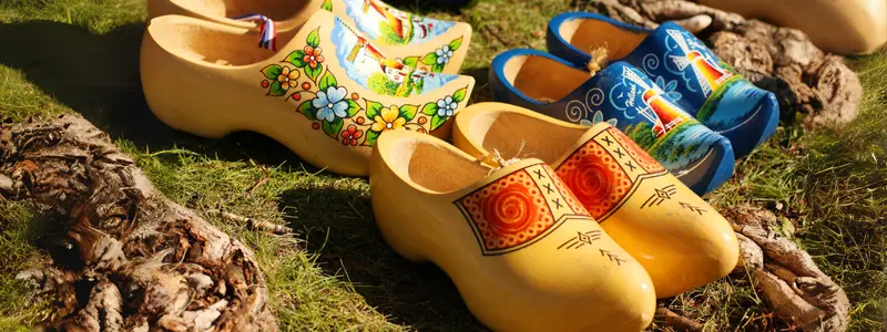 Wooden clogs with painted colorful floral decorations.