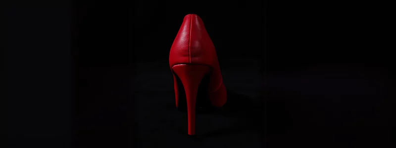 Stiletto Heels: Remarkable Symbol 5 Emerging from the darkness, the back of a blood-red elegant stiletto heel.