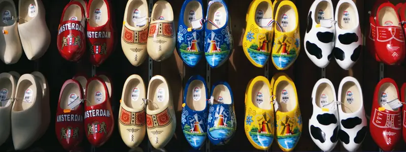 Traditional Dutch clogs in various color styles, featuring painted windmills or the city Amsterdam.