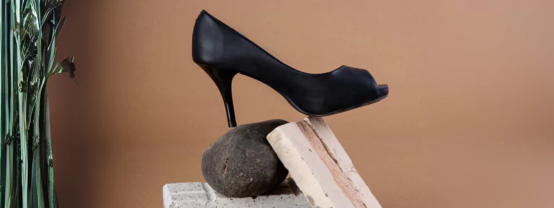 A classic elegant stiletto in a cone style balancing on a stone.