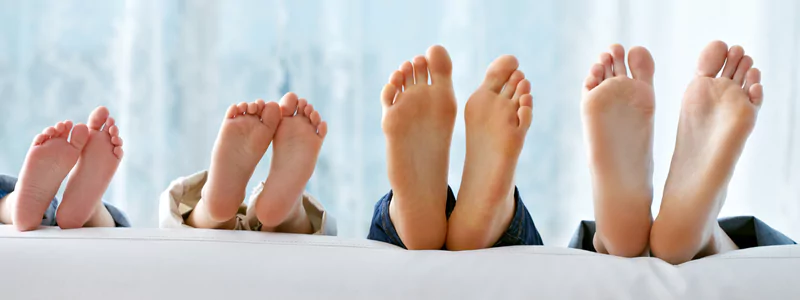 Four pairs of feet arranged from smallest to largest.