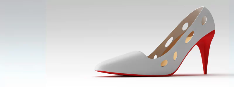 A white designer eco-friendly shoe with cut-out holes and a red cone heel.