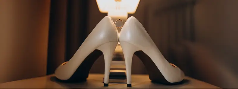 French Heels: Unleashing Elegance & Graceful Charm 2 Elegant white high heels placed in a cozy, warmly lit room – inclusive fashion statement for men who wear heels